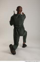 ERIC KNEELING POSE WITH GUNS